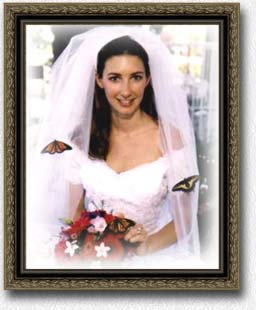bride with butterfly release at wedding with favors and butterfly favors